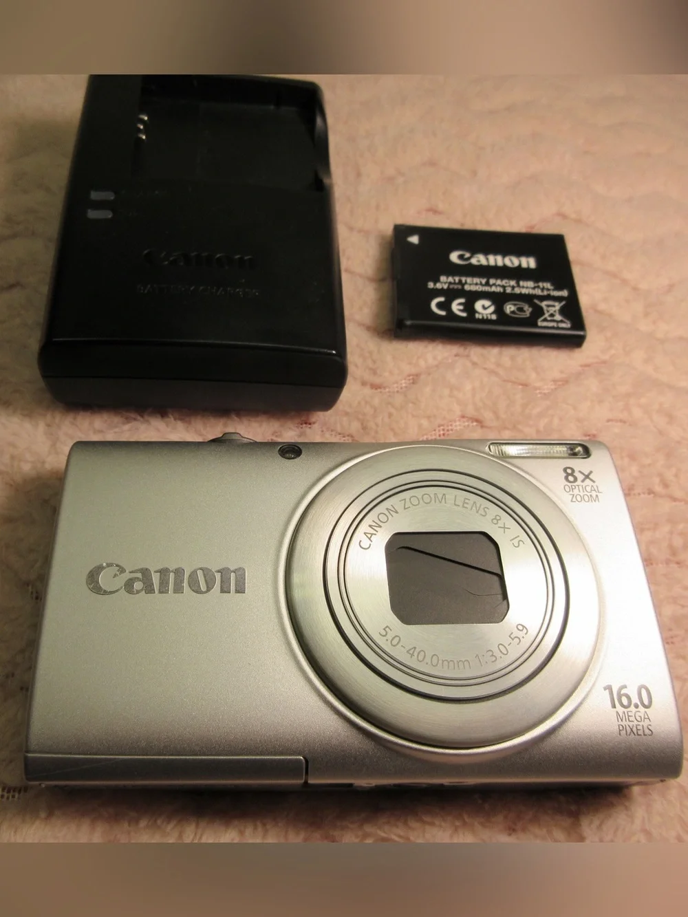 Canon Silver Compact Camera with Black Charger and Accessories
